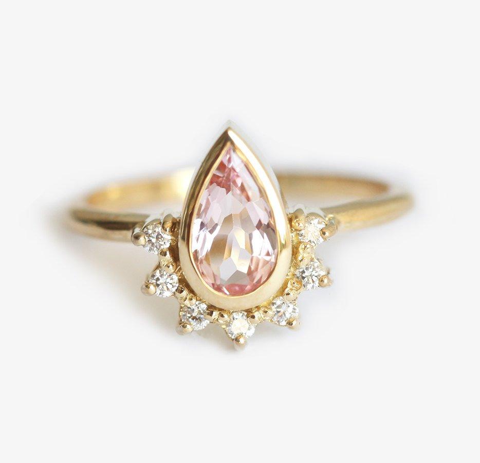 Pear-shaped pink sapphire with diamond halo