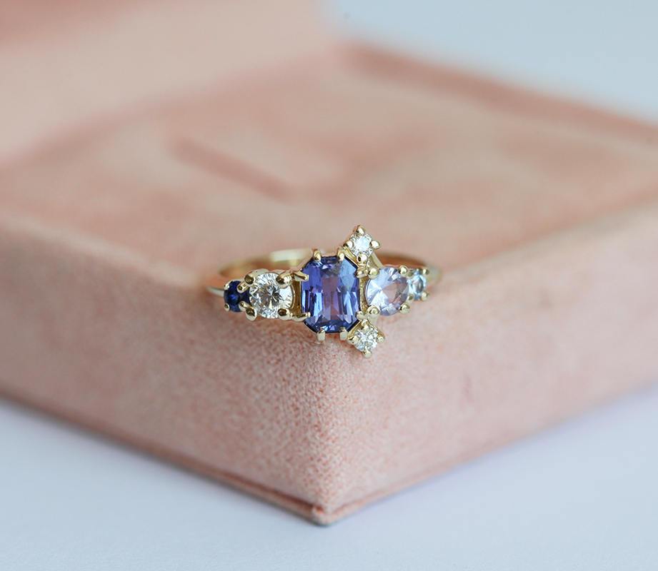 Violet blue radiant sapphire cluster ring with diamonds