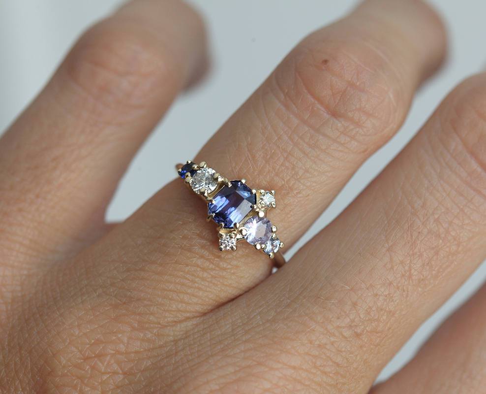 Violet blue radiant sapphire cluster ring with diamonds