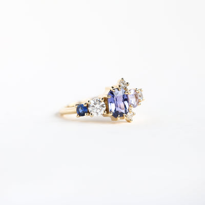 Violet blue radiant sapphire cluster ring with diamonds