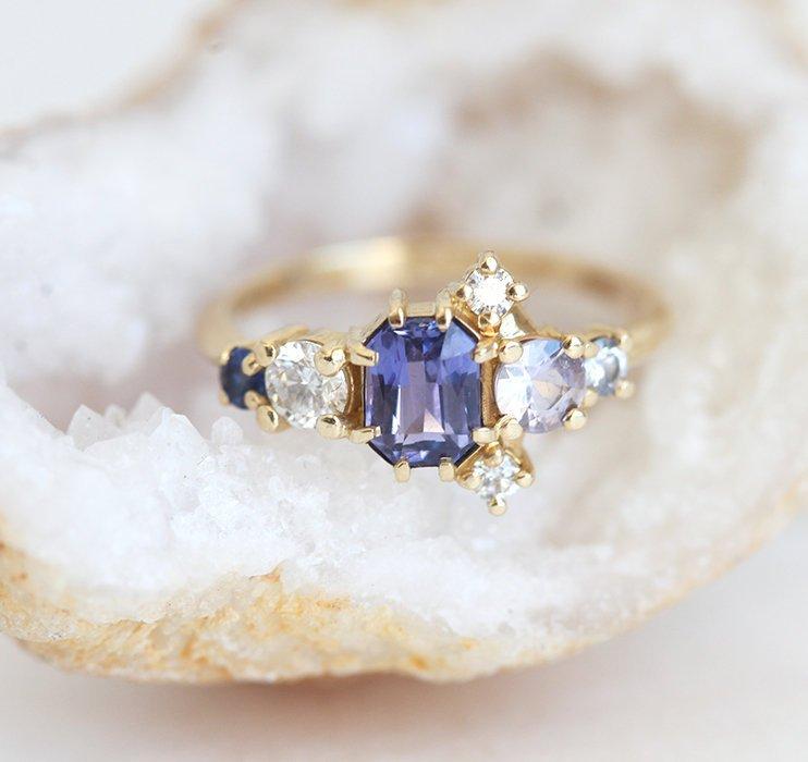 Violet blue radiant sapphire cluster ring with diamonds