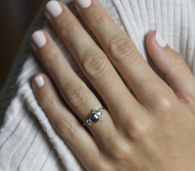 Violet blue radiant sapphire cluster ring with diamonds