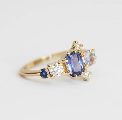 Violet blue radiant sapphire cluster ring with diamonds