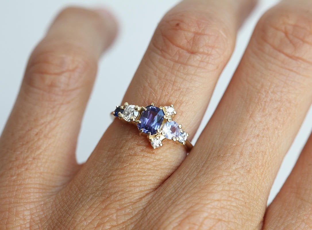 Violet blue radiant sapphire cluster ring with diamonds