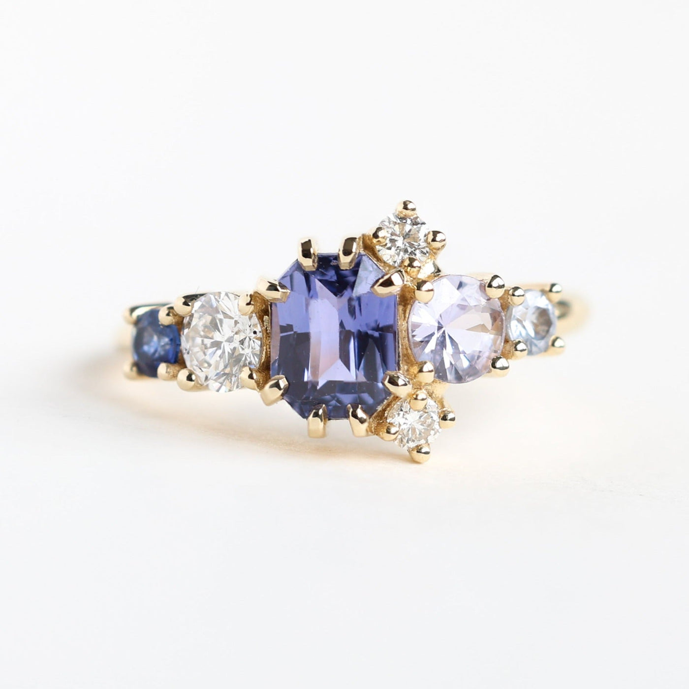 Violet blue radiant sapphire cluster ring with diamonds