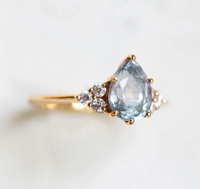 Pear-shaped blue green sapphire ring with side diamonds