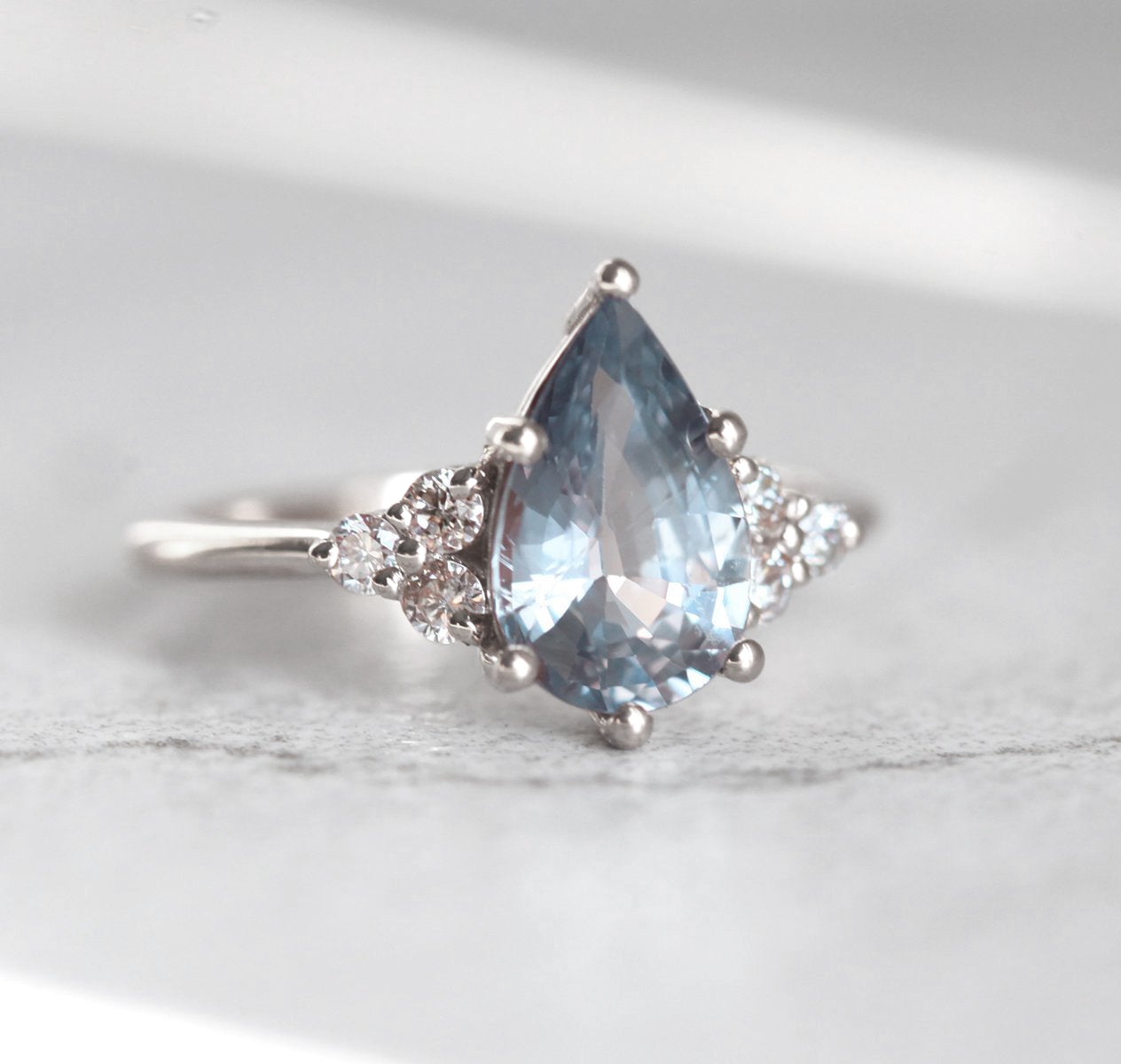 Pear-shaped blue sapphire ring with side diamonds