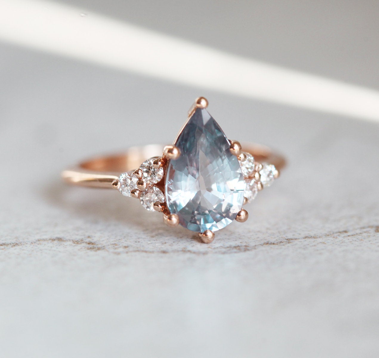 Pear-shaped blue sapphire ring with side diamonds