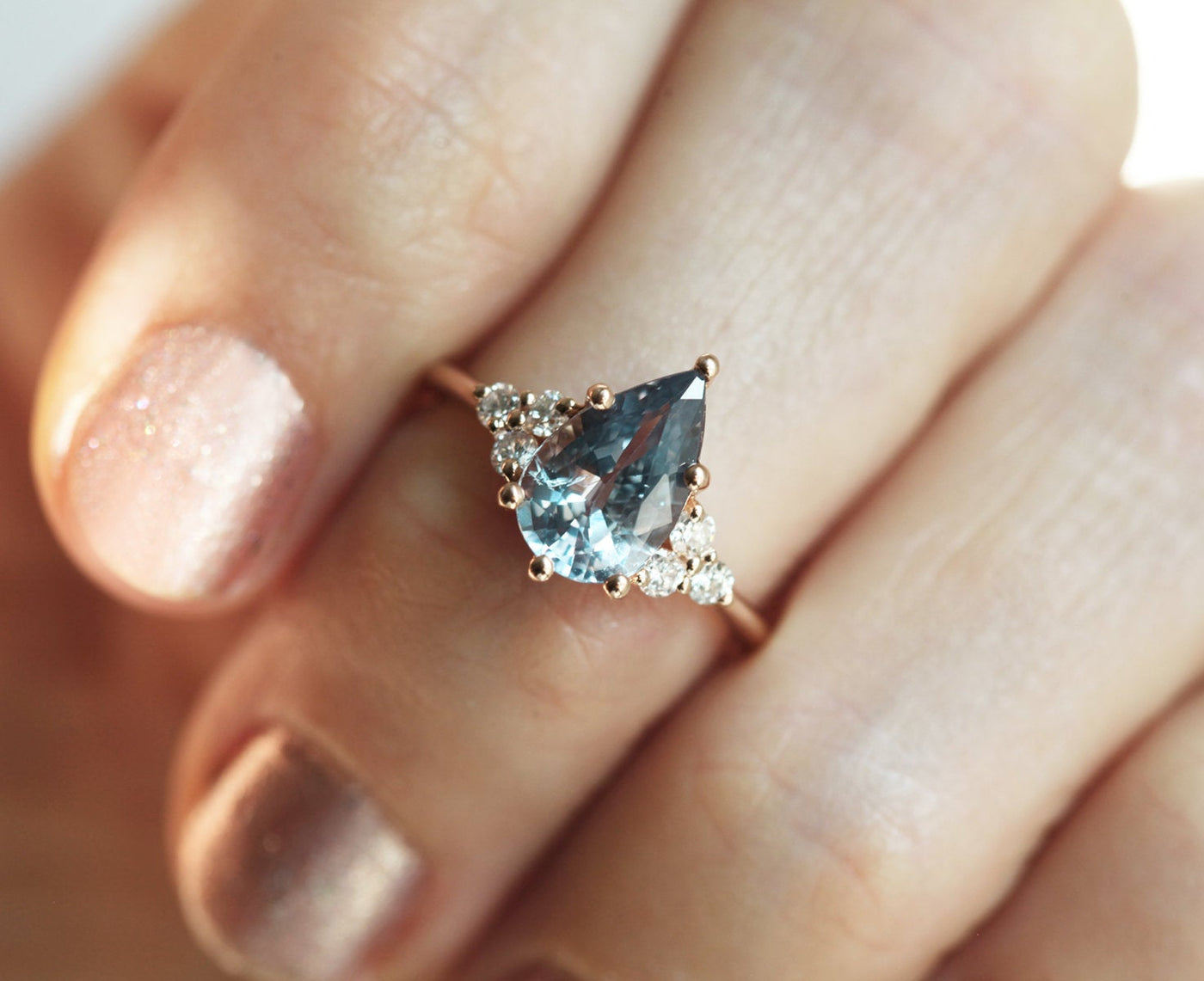 Pear-shaped blue sapphire ring with side diamonds