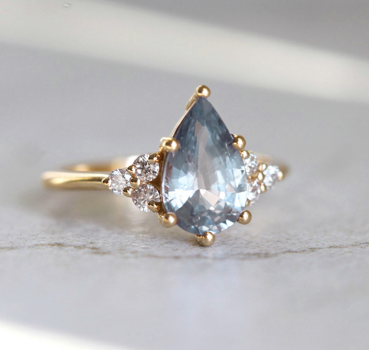 Pear-shaped blue sapphire ring with side diamonds