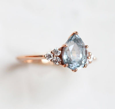 Pear-shaped sapphire ring with diamond cluster