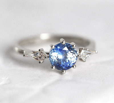 Round blue sapphire ring with white side diamonds
