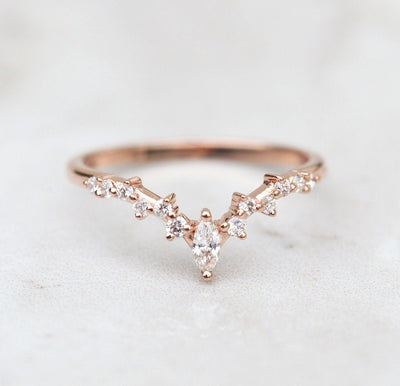 Oval-shaped peach sapphire ring with diamond cluster