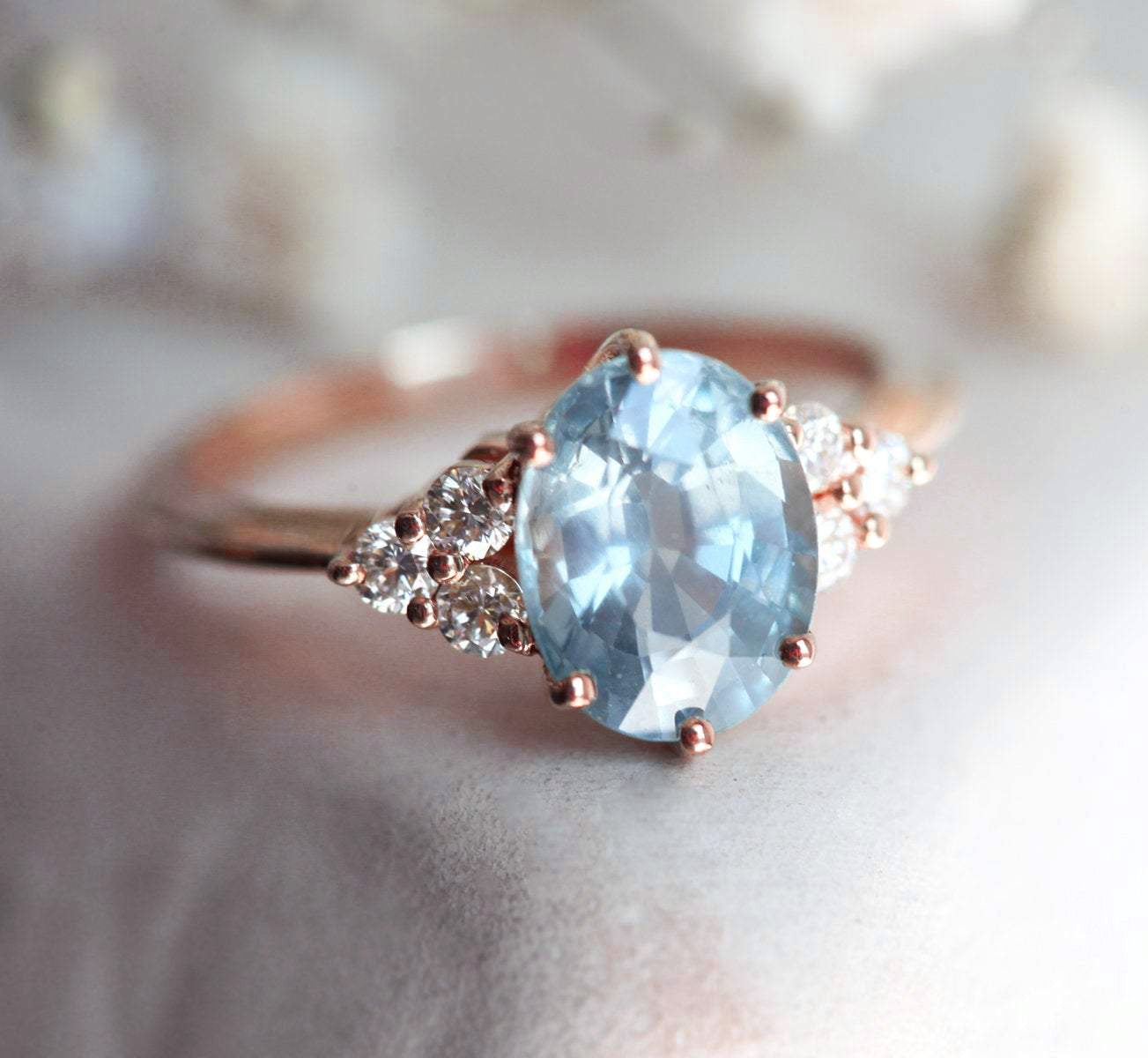 Oval-shaped blue sapphire ring with diamond cluster