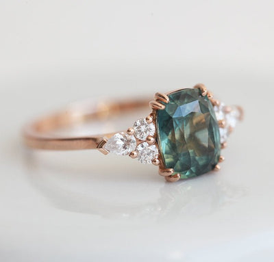 Teal cushion-cut sapphire ring with side diamonds