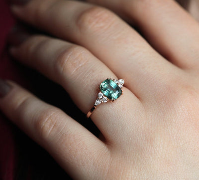 Teal cushion-cut sapphire ring with side diamonds