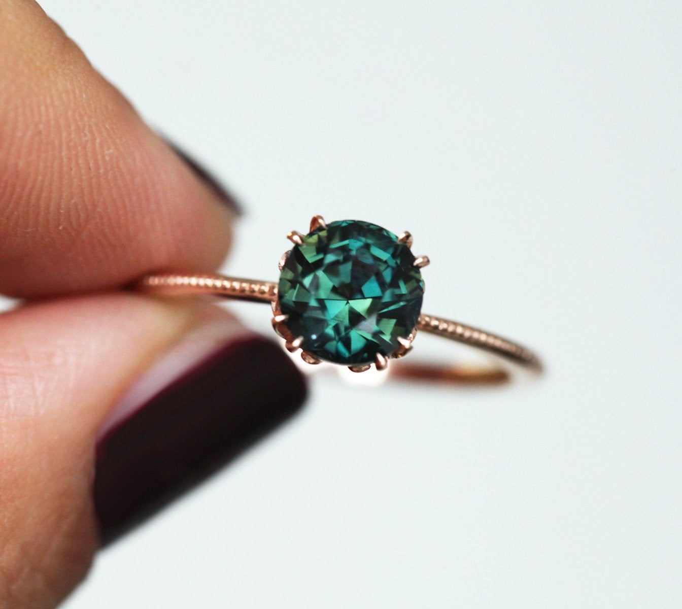 Round blue green solitaire sapphire ring