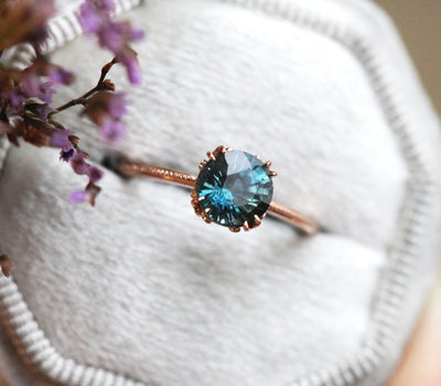 Round teal solitaire sapphire ring