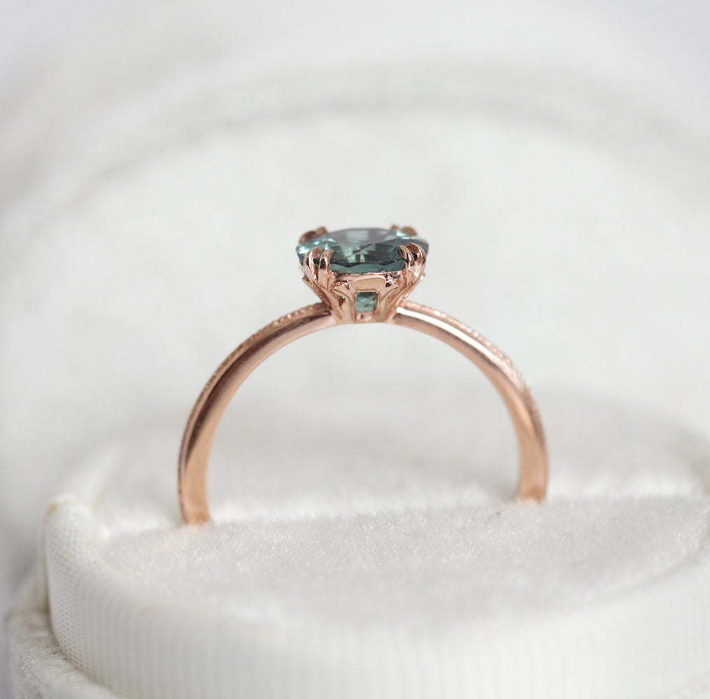 Round teal solitaire sapphire ring