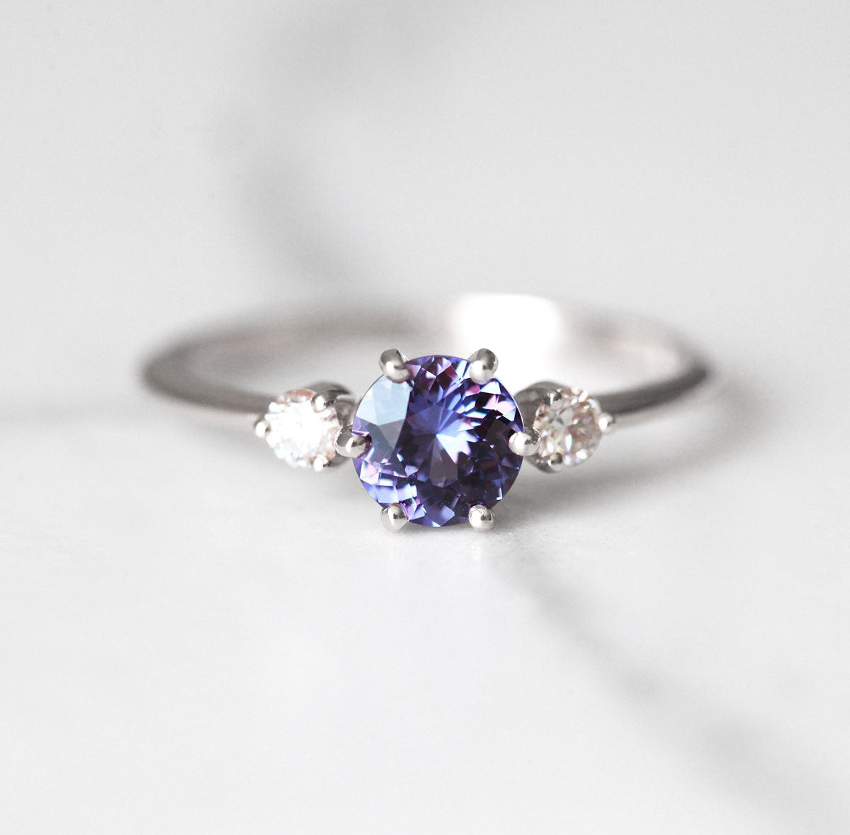 Round blue purple sapphire ring with side diamonds