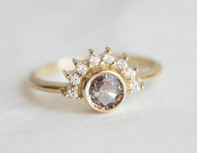 Round peach pink sapphire ring with diamond halo