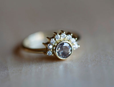 Round peach pink sapphire ring with diamond halo