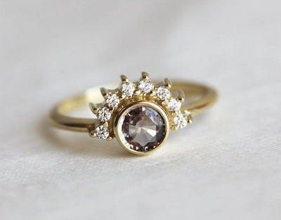 Round peach pink sapphire ring with diamond halo