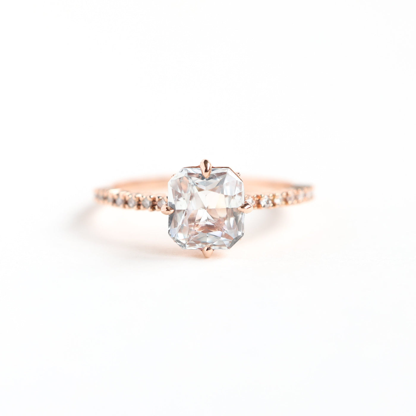 Radiant white sapphire ring with side diamonds