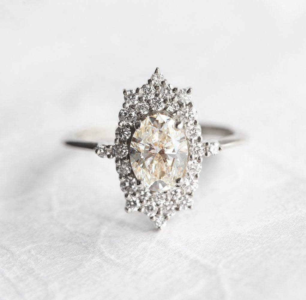 Oval White Diamond Halo Ring with lots of side White Diamonds