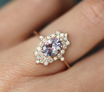 Oval-shaped lavender sapphire ring with diamond halo