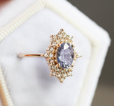 Oval-shaped lavender sapphire ring with diamond halo
