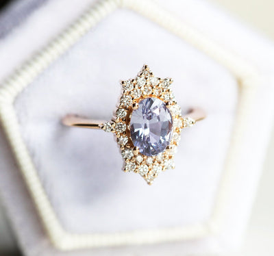 Oval-shaped lavender sapphire ring with diamond halo