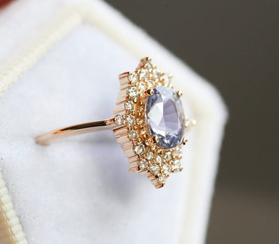 Oval-shaped lavender sapphire ring with diamond halo