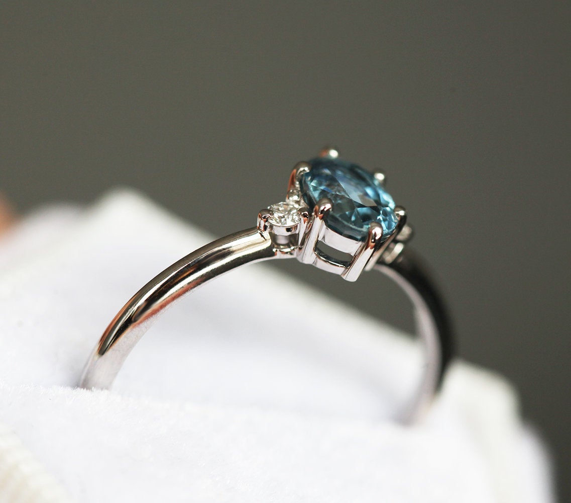 Oval-shaped blue sapphire ring with side diamonds