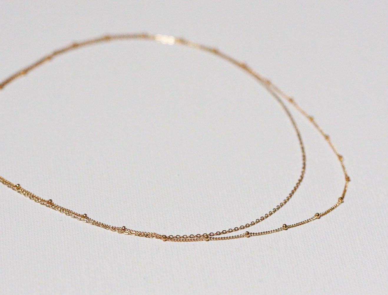 Layered satellite gold necklaces