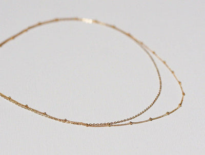 Layered satellite gold necklaces