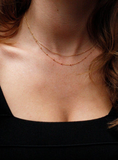 Layered satellite gold necklaces