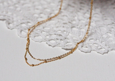 Layered satellite gold necklaces