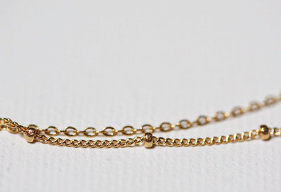 Layered satellite gold necklaces