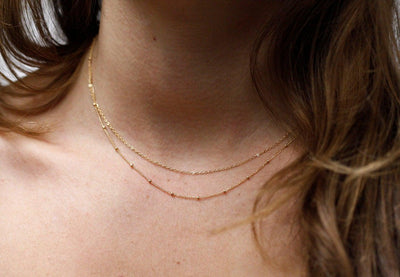 Layered satellite gold necklaces