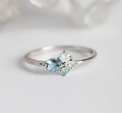 Blue Oval Aquamarine Cluster Ring with Side Moonstones and Aquamarine Stones