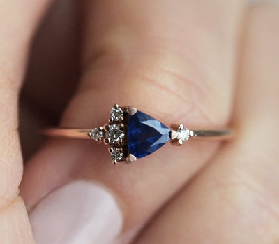 Blue triangle-cut sapphire ring with white diamond cluster