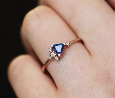 Blue triangle-cut sapphire ring with white diamond cluster