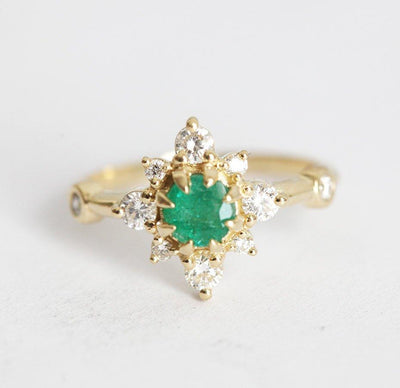 Emerald Ring with green emerald, diamonds, and halo design in 14k gold.