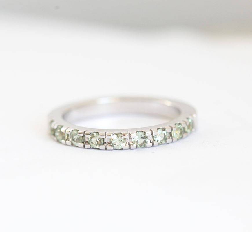 Round light green sapphire eternity ring