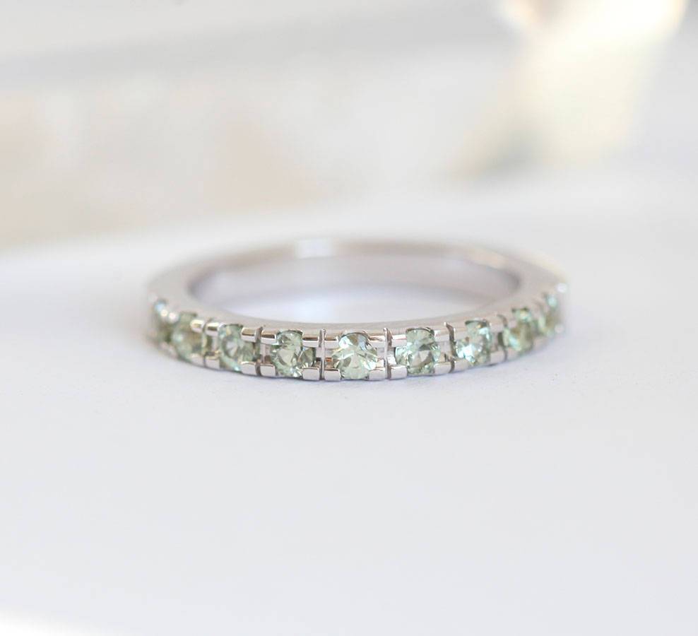 Round light green sapphire eternity ring