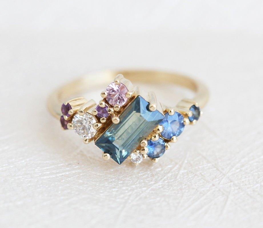 Baguette-shaped blue sapphire ring with diamond, amethyst and sapphire cluster