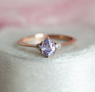 Pear-shaped purple sapphire ring with round white side diamonds