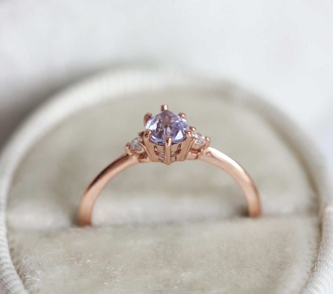 Pear-shaped purple sapphire ring with round white side diamonds