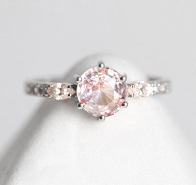 Round pink sapphire ring with side diamonds